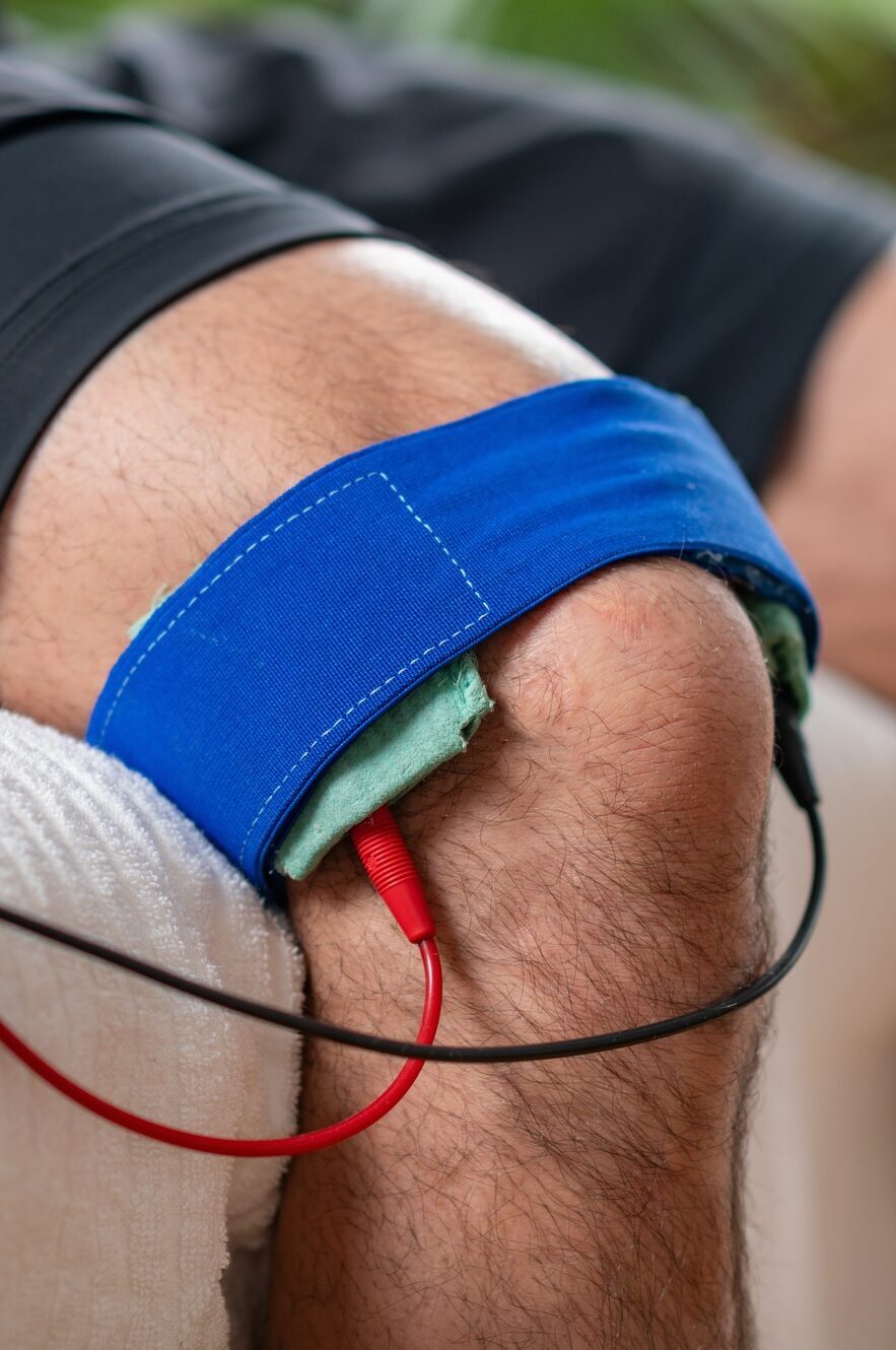 A patient undergoing knee therapy with electrotherapy treatment for pain relief and rehabilitation.