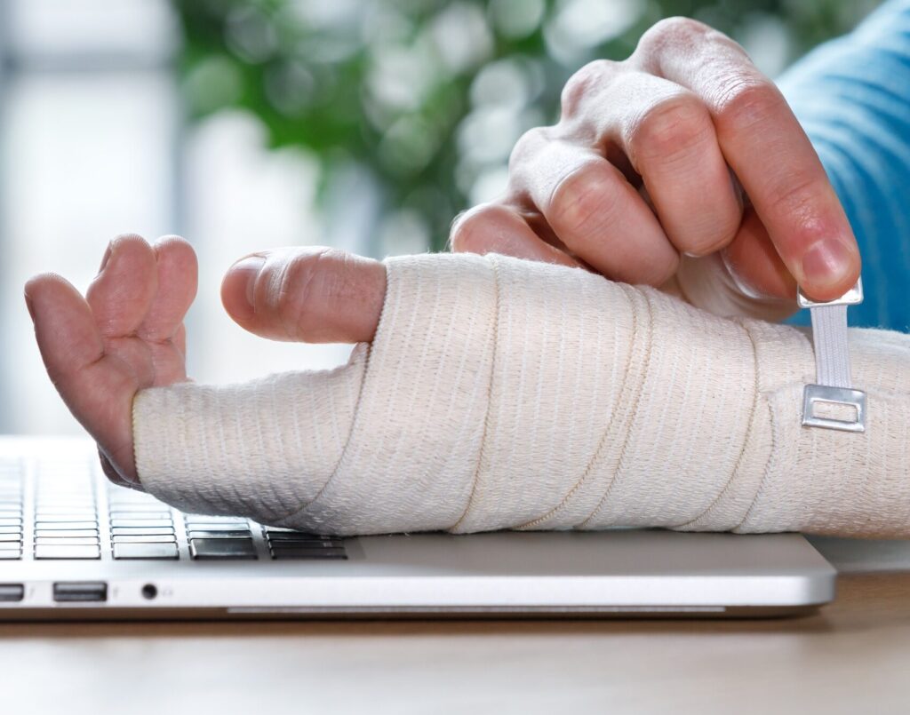 man arms wrapping his painful wrist with orthopedic bandage
